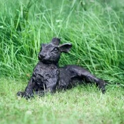 Lying Down Hare Bronze Sculpture -Sophie Allport BSHALD01 Laying Down Bronze Hare Lifestyle Portrait High Res 2 web image