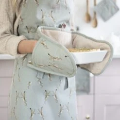 Boxing Hares Adult Apron -Sophie Allport boxing hares apron double oven glove holding pie kitchen lifestyle high res square