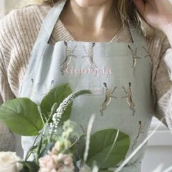 Boxing Hares Adult Apron -Sophie Allport boxing hares apron personalisation close up lifestyle high res square